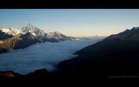 Sunrise over Mattertal, with Zermatt in valley below beneath clouds